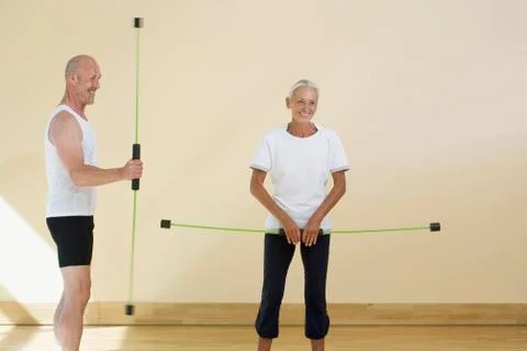 A mature man and a senior woman using aerobic flex bars Stock Photos