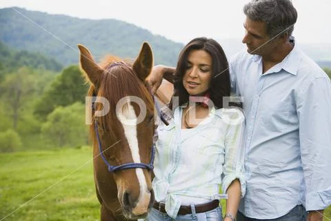 Mature man and a woman with a horse Stock Photos
