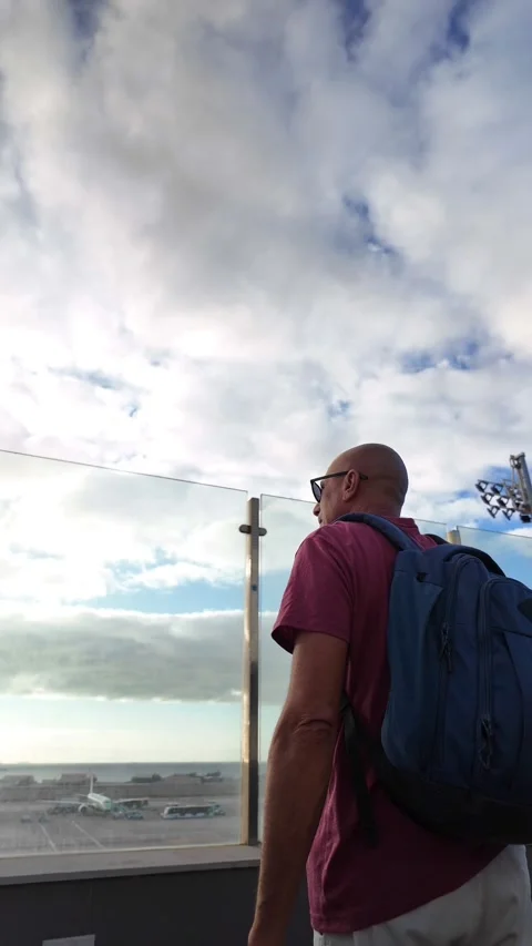 Mature man with backpack watching planes at Gran Canaria airport Stock Footage 345362314