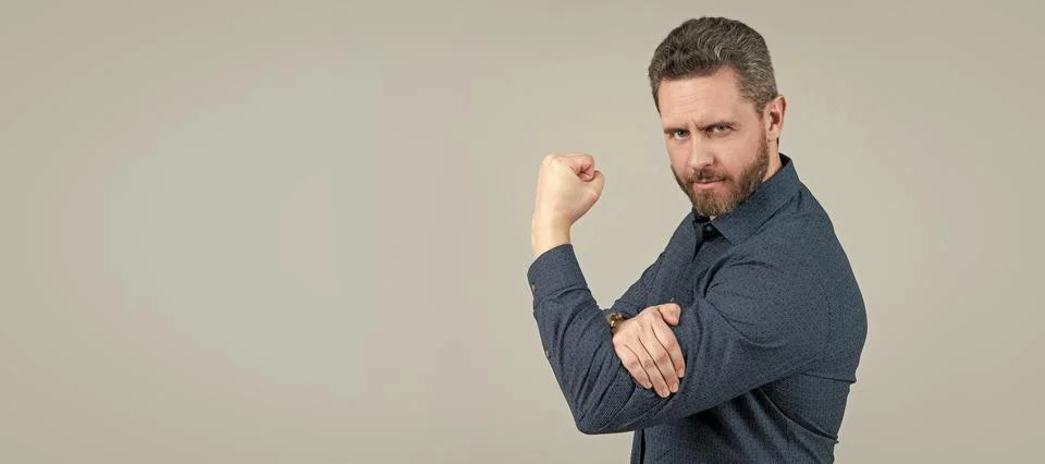 Mature man bend arm in L-shape with fist pointing upwards obscene gesture grey Stock Photos