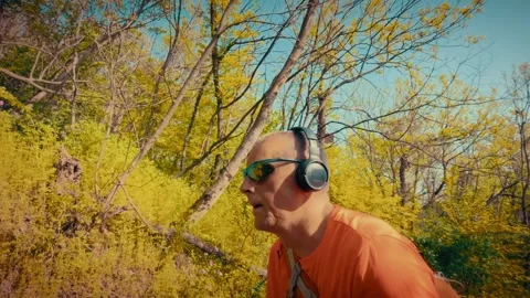 Mature man breathing deeply in forest, mental health relief, active senior in Stock Footage 334090578