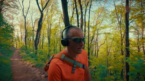 Mature man breathing deeply in forest, mental health relief, active senior in Stock-Footage 334090614