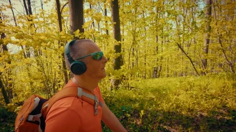 Mature man breathing deeply in forest, mental health relief, active senior in Stock Footage 334090720