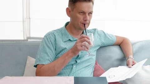 Mature man browsing documents in a cafe Video stock 94509421