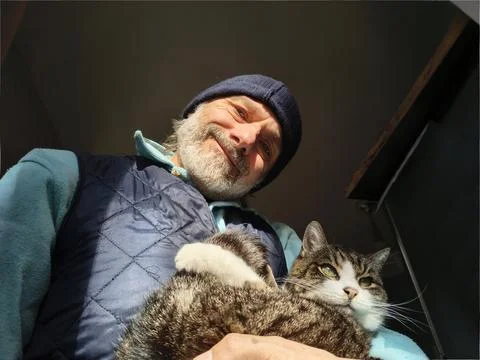Mature man with a cat Stock Photos
