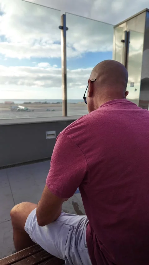 Mature man checking his flight on a smartphone at the airport Stock Footage 345362371