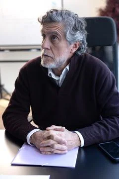 Mature man contemplating in office setting Stock Photos