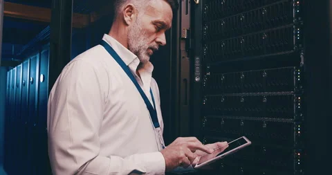 Mature man in data center with tablet, n... | Stock Video | Pond5
