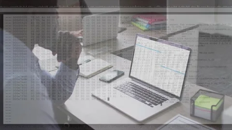 Mature man at desk studying spreadsheet while laptop streaming log overlay Stock Footage 332428608