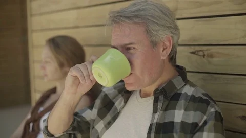 Mature man drinking coffee outside of cabin Stock Footage 75172828