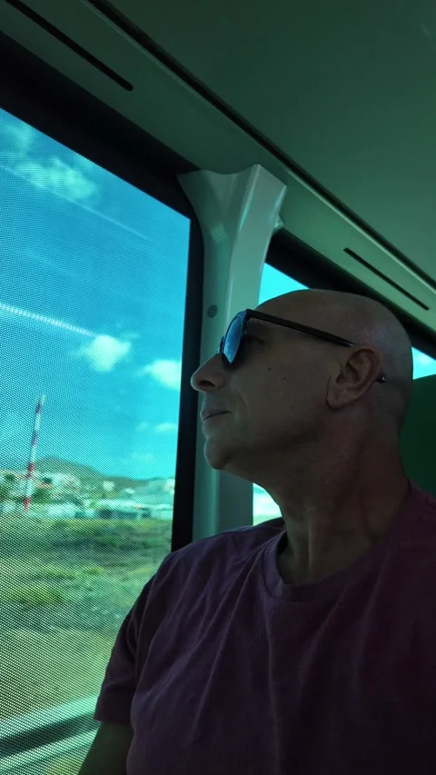Mature man enjoying the view while traveling on a bus Stock Footage 345362317
