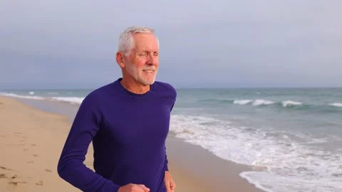 Mature Man Exercising At The  Beach 動画素材 219887830