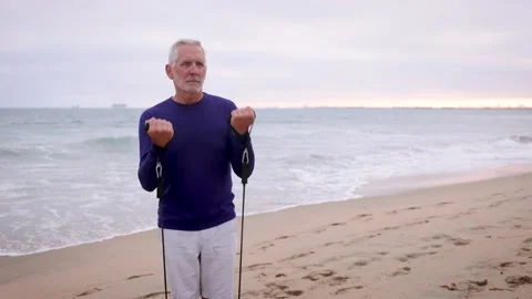 Mature Man Exercising At The  Beach Video stock 219887878