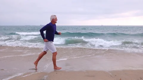 Mature Man Exercising At The  Beach Video stock 259903122