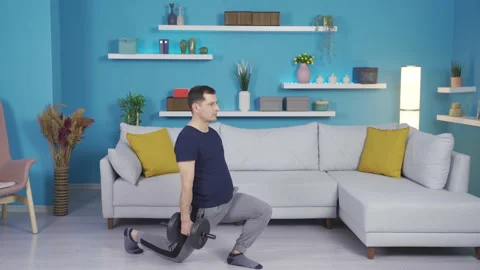 Mature man exercising using equipment at home. 스톡 동영상 232299304