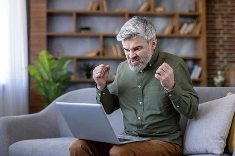 Mature man experiencing computer stress and technology frustration Stock Photos