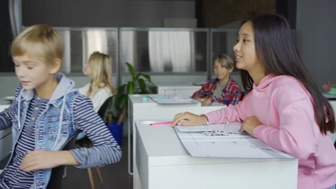 Mature man explaining code to talking diverse students Stock Footage 142493353
