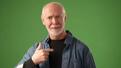 Mature Man Expressing Emotion in Front of a Solid Green Background Stock Footage 305569052