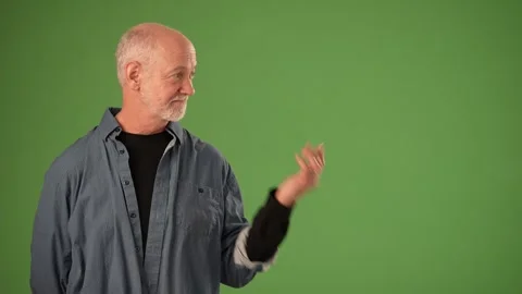 Mature Man Expressing Emotion on a Solid Green Background for Announcement Stock Footage 305522989