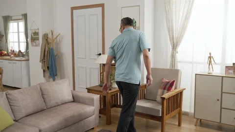Mature man finding smartphone behind sofa cushion Video stock 190115140