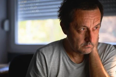Mature man focused on computer screen in home office Stock Photos