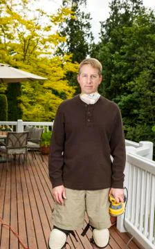 Mature man getting ready to work on outdoor deck Stock Photos