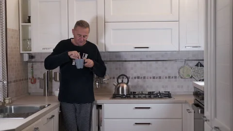 Mature man has breakfast 動画素材 165663796