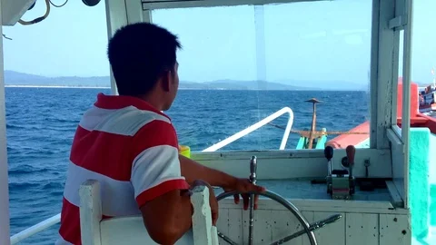 Mature man at the helm of a boat Video stock 101051936