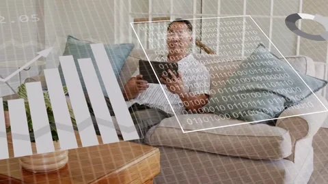 Mature man holding tablet on sofa, tapping and activating data HUD, monitoring Stock Footage 334744550