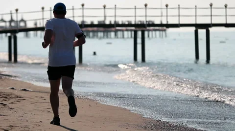 Mature Man Jogging On Sandy Beach Stock Footage 40943244
