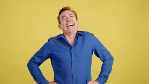 Mature man laughing while standing with arms crossed Video stock 234859060