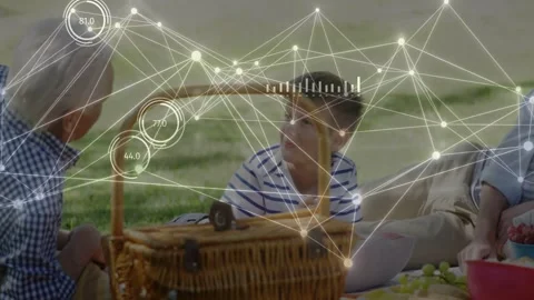 Mature man leaning and gesturing boy turning toward basket to check while tech Stock Footage 332592173