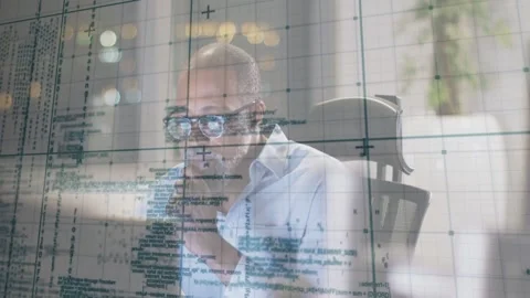 Mature man leaning in at desk, analyzing code errors with tech grid overlays Stock Footage 332981418