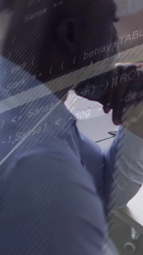Mature man leaning resting chin analyzing papers as screen glare overlaying code Stock Footage 333079853