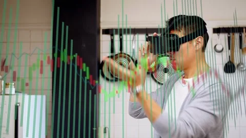 Mature man lifting AR headset activating finance chart in kitchen pinching bars Stock Footage 333817902