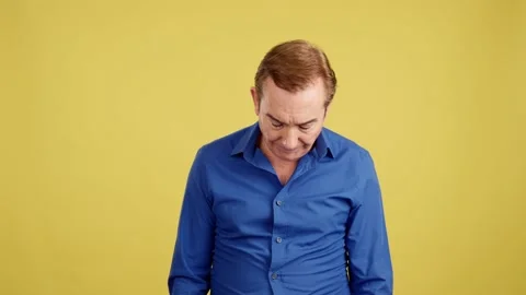 Mature man looking at camera with sad expression Stock Footage 232910697