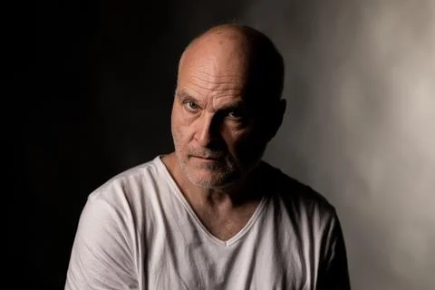 Mature man looking serious with dramatic lighting Stock Photos