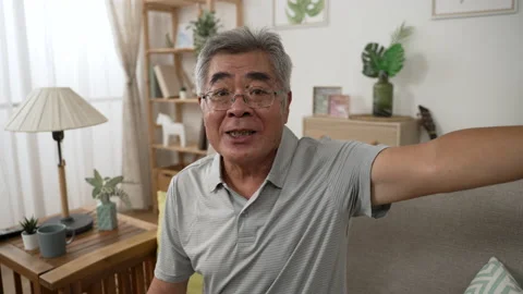 Mature man make video call by smartphone on sofa Video stock 165756221