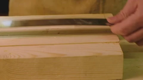 A mature man makes a marking on the board with a ruler Stock Footage 182228193