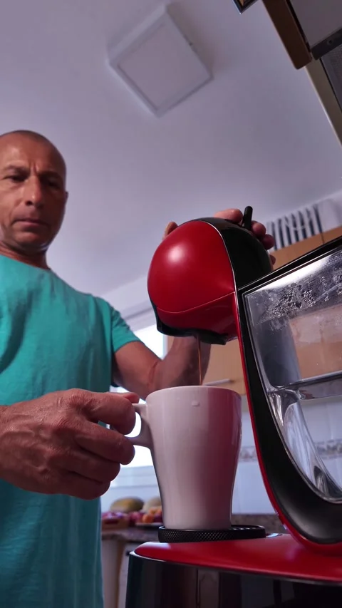 Mature man making an espresso coffee at home Stock Footage 345666372