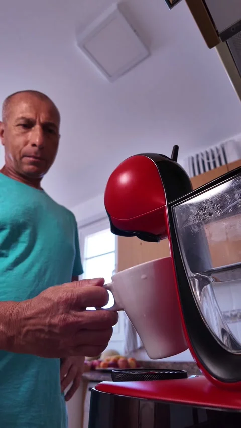 Mature man making an espresso in his kitchen Stock Footage 345666370