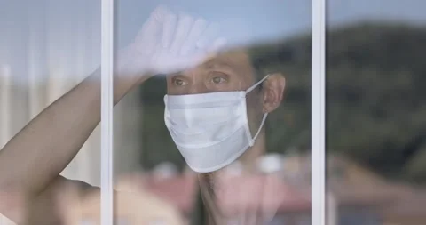 Mature Man With Mask Looking Through The Window Stock Footage 136852816