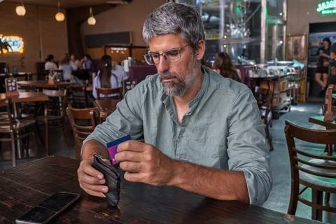 Mature man paying bill using credit card Stock Photos