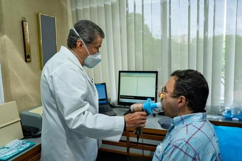 Mature man performing pulmonary function test and spirometry Stock Photos