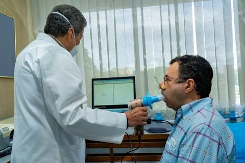 Mature man performing pulmonary function test and spirometry Stock Photos