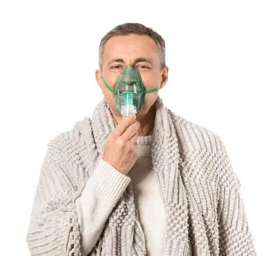 Mature man with plaid using nebulizer on white background Stock Photos
