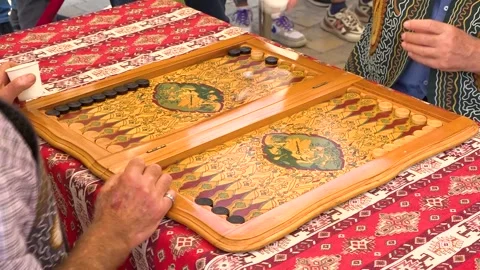 Mature Man Playing Backgammon Game on a Wooden Table with Dice 스톡 동영상 252267037