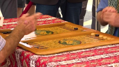 Mature Man Playing Backgammon Game on a Wooden Table with Dice Stock Footage 252267038
