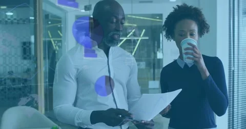 Mature man scanning doc and pointing, woman sipping while animated business Stock Footage 330980939
