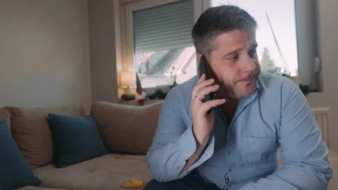 Mature man sit indoor talking on smartphone hearing bad news Stock Footage 166174191